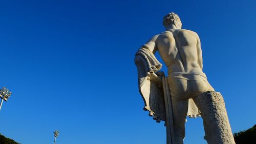 Low angle view of statue against clear blue sky