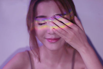 Close-up portrait of a beautiful young woman over white background