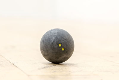 Close-up of squash ball on court