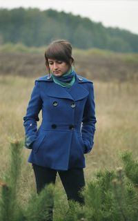 Woman standing on grassy field