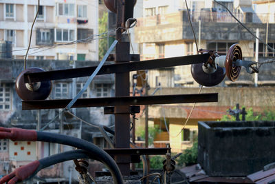 Close-up of bicycle on railing against buildings