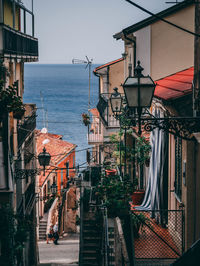 Buildings by sea against clear sky