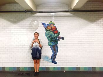 Full length of woman standing on wall