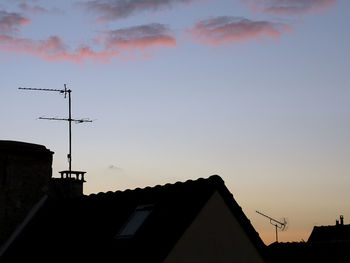 High section of building against sky at sunset