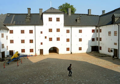 People walking on street amidst buildings in town