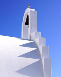 High section of built structure against clear blue sky