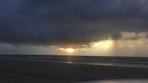 Scenic view of beach against sky during sunset