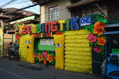 Multi colored graffiti on street against buildings in city
