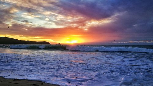 View of sea against cloudy sky during sunset