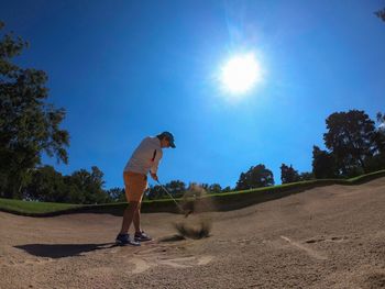 Man playing golf at course