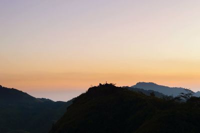 Scenic view of silhouette mountain against dramatic sky