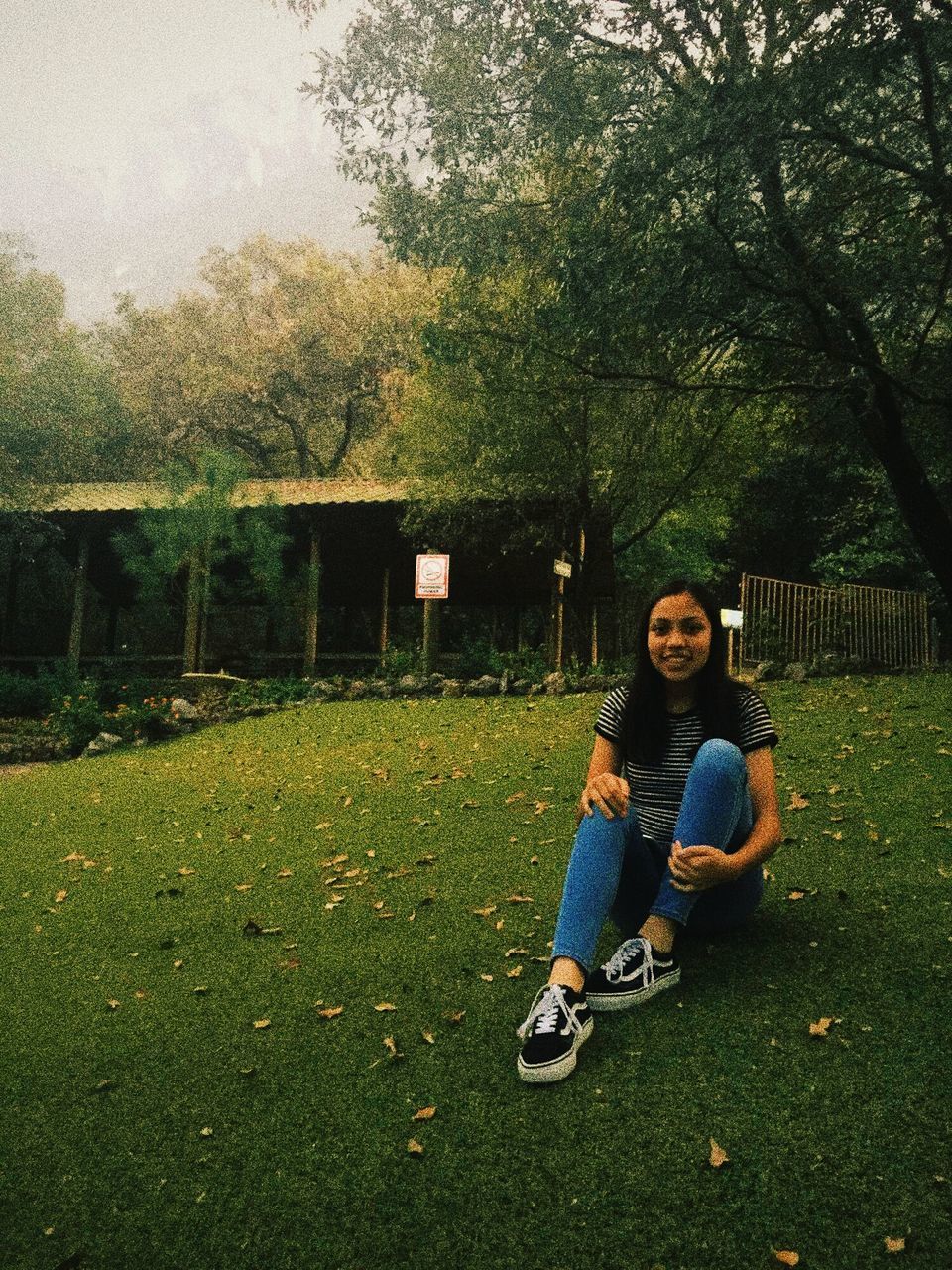 tree, real people, full length, one person, sitting, grass, leisure activity, lifestyles, young adult, growth, outdoors, day, young women, nature, architecture, people