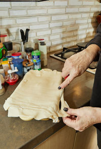 Chef prepares souffle of potatoes, zucchini, cauliflower , yellow cheese according to french recipe