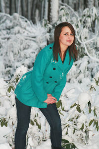 Portrait of a young woman standing in snow