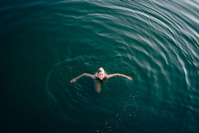 High angle view of woman swimming in sea
