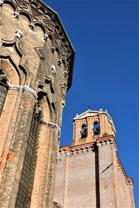 Low angle view of bell tower against blue sky