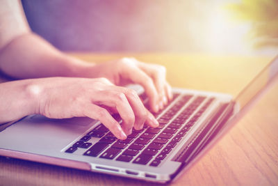 Close-up of woman using laptop