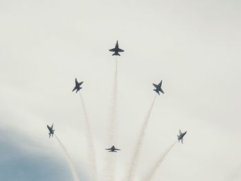 Low angle view of airplane flying against sky