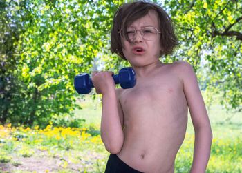 Portrait of shirtless boy, training bodybuilding