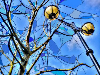 Low angle view of lamp post against blue sky