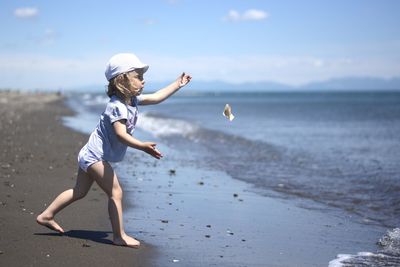 Full length of woman on beach against sky