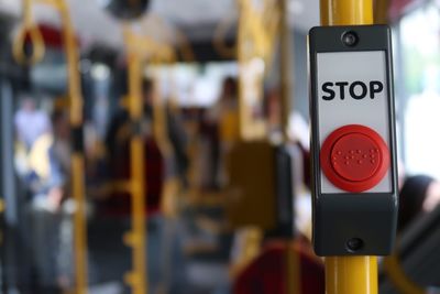 Close-up of stop sign in bus