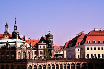 View of buildings in city against clear sky