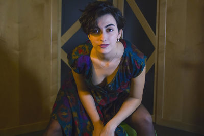 Portrait of young woman sitting at home