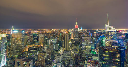 High angle view of city lit up at night