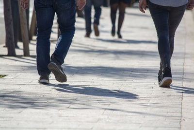 Low section of people walking on street