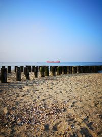 Scenic view of beach against clear blue sky