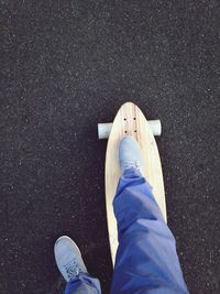 Low section of person skateboarding on street