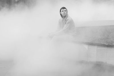 Man sitting on retaining wall