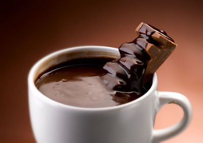 Close-up of coffee cup against black background
