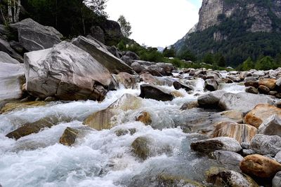 Scenic view of waterfall against sky