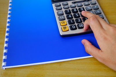 Person using calculator on table