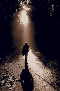 Full length of man walking on dirt road