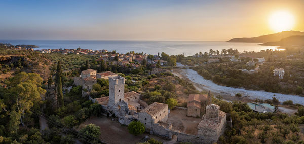 High angle view of townscape by sea against sky