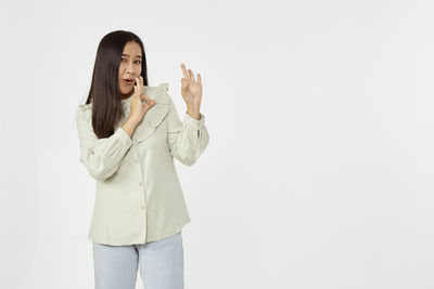 Woman standing against white background