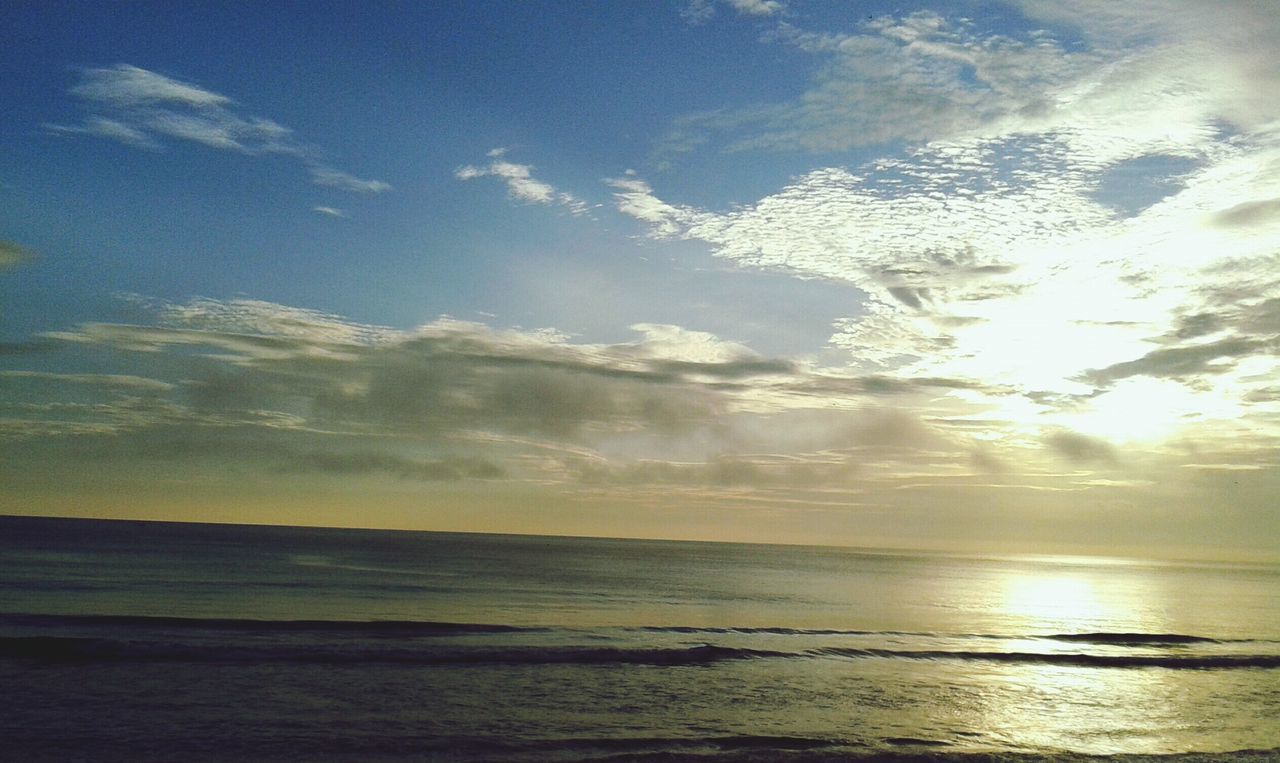 sea, water, horizon over water, scenics, tranquil scene, tranquility, sky, beauty in nature, beach, nature, idyllic, sunset, shore, cloud - sky, sun, reflection, sunlight, cloud, sunbeam, outdoors