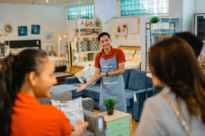 Side view of friends working at restaurant