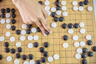 Cropped hand playing japanese checkers