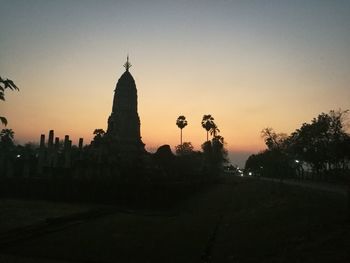 Silhouette temple against sky during sunset