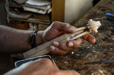 Violin maker luthier hand working a new violin scroll