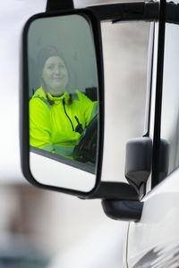 Woman driving garbage truck