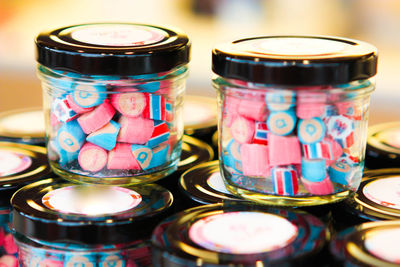 Close-up of multi colored glass jar on table