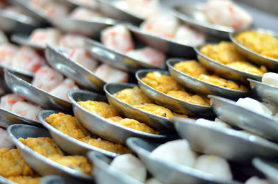 Various food in plates for sale at market stall