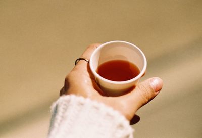 Close-up of hand holding tea cup