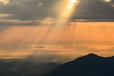 Scenic view of silhouette mountains against sky during sunset