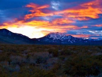 Scenic view of snowcapped mountains against sky during sunset